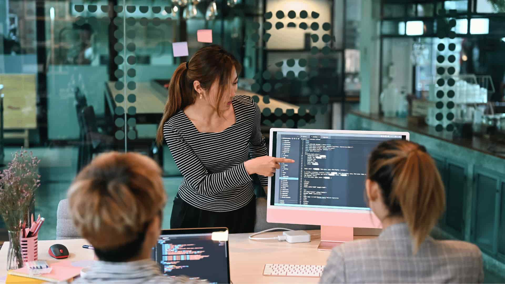 Woman showing her team Magento coding