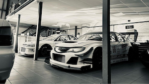 Roger Clark Motorsport automative eCommerce client case study from magic42, showing high quality silver cars in a slick garage